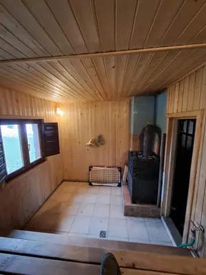 an inside view of a room in a wooden house at Drulenu sodyba in Drūlėnai