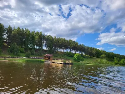 a house on the shore of a body of water at Drulenu sodyba in Drūlėnai