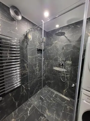 a bathroom with a shower with a glass door at E. D. Elite Apartment in Šiauliai
