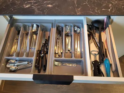 a drawer with utensils in it on a counter at E. D. Elite Apartment in Šiauliai