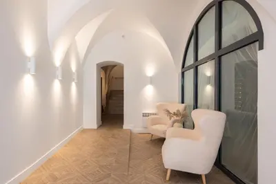 a living room with two chairs and a window at cohost I Premium Residence I on the Historic Pilies Street I Self Check-in in Vilnius