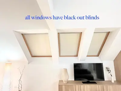 all windows have black out blinds in a room with a tv at cohost I Premium Residence I on the Historic Pilies Street I Self Check-in in Vilnius