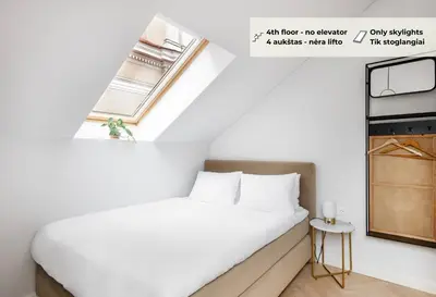 a small bedroom with a bed and a window at GRAND CROWN in Vilnius