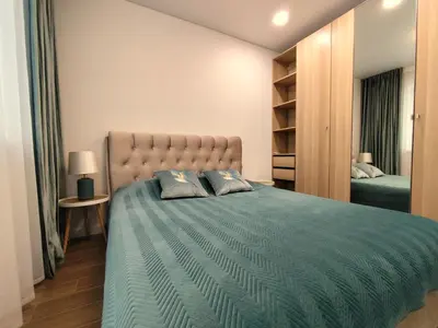 a bedroom with a large bed with two pillows at NEW Apartment J22, Free Private Parking, Terrace, Self Check-in in Kaunas
