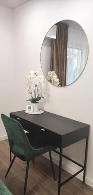 a black desk with a mirror and a green chair at NEW Apartment J22, Free Private Parking, Terrace, Self Check-in in Kaunas