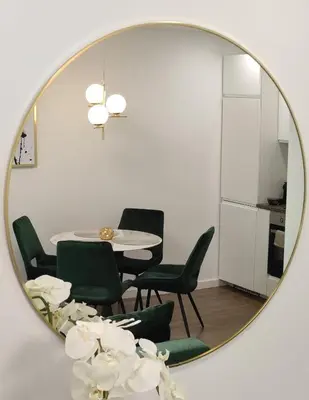 a mirror reflecting a dining room with a table and chairs at NEW Apartment J22, Free Private Parking, Terrace, Self Check-in in Kaunas