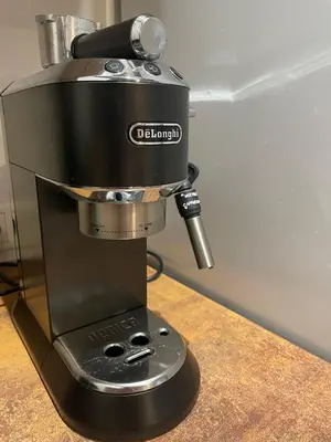 a black coffee maker sitting on a counter at Courtyard gallery apartment with free parking in Kaunas
