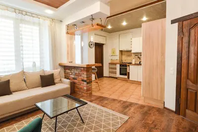 a living room with a couch and a table at Courtyard gallery apartment with free parking in Kaunas