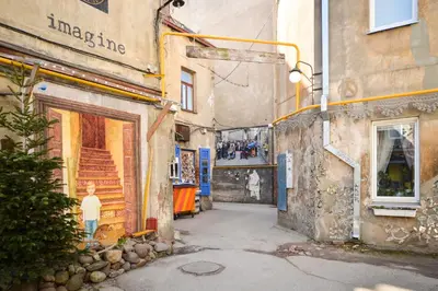 a painting of a street in an alley at Courtyard gallery apartment with free parking in Kaunas