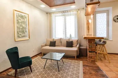 a living room with a couch and a chair at Courtyard gallery apartment with free parking in Kaunas