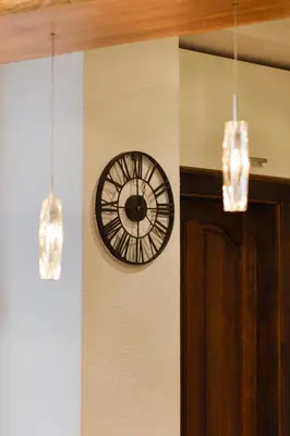 a clock on the side of a wall with lights at Courtyard gallery apartment with free parking in Kaunas
