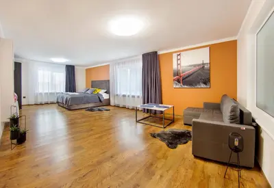 a living room with a couch and a bed at Namo-pirties nuoma Vinkšnėnuose in Vijoliai