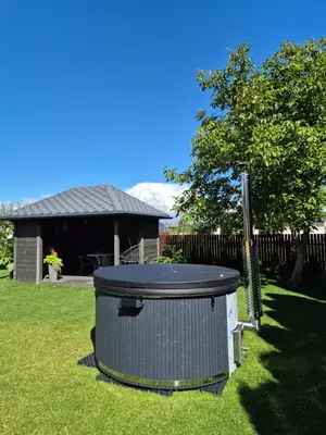 a large trash can sitting in the grass at Namo-pirties nuoma Vinkšnėnuose in Vijoliai