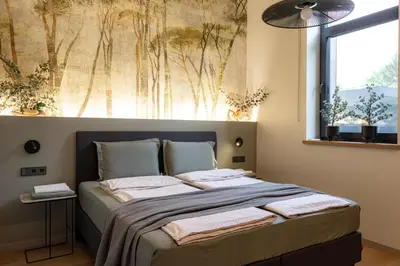 a bedroom with a bed with towels on it at Pine house in Zujūnai
