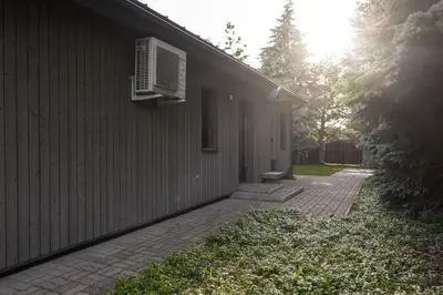 a building with an air conditioner on the side of it at Pine house in Zujūnai