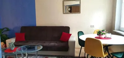 a living room with a couch and a table at EMVIKA apartament in Šiauliai