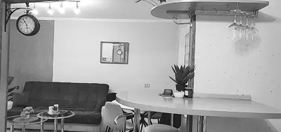 a living room with a table and a couch at EMVIKA apartament in Šiauliai