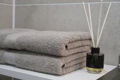 a pile of towels on a table in a bathroom at Apartment Secret in Jonava