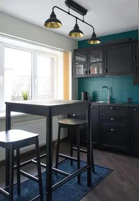a kitchen with a large table and two stools at Apartment Secret in Jonava