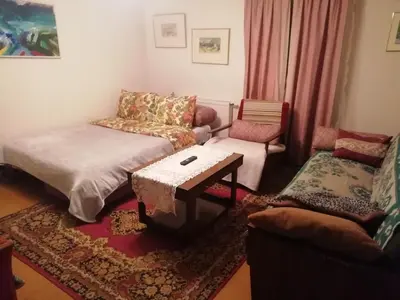 a living room with a couch and a table at Poilsio kambariai Salake in Salakas