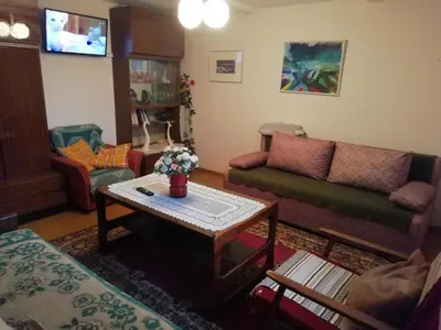 a living room with a couch and a table at Poilsio kambariai Salake in Salakas