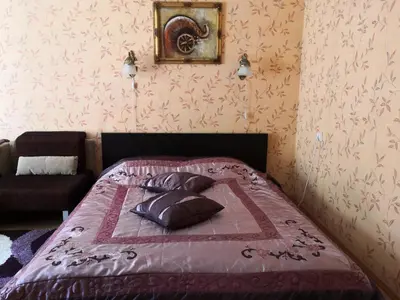 a bed with two pillows on it in a bedroom at Vieno kambario butas su balkonu in Kaunas