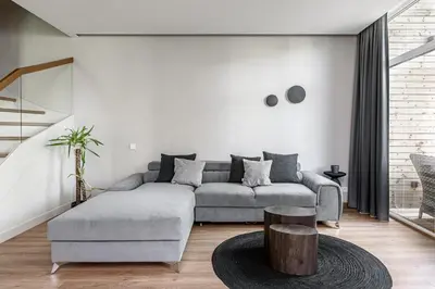 a living room with a couch and a table at Miško Spa namas in Molėtai