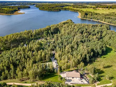 an aerial view of an island in the middle of a lake at Miško Spa namas in Molėtai