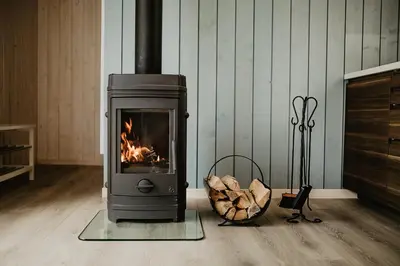 a stove in a room with a fire in it at Atokampis Boutique SPA & Resort in Anglininkai