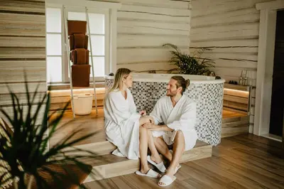 a man and a woman sitting in a bathtub at Atokampis Boutique SPA & Resort in Anglininkai