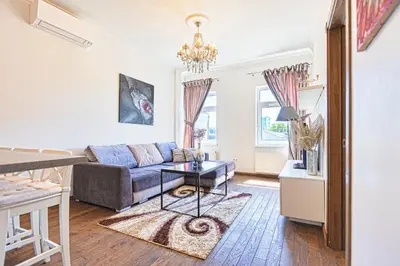 a living room with a couch and a table at Central Stylish Well Equiped Apartments - Self Check-in in Vilnius