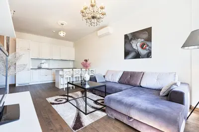 a living room with a couch and a table at Central Stylish Well Equiped Apartments - Self Check-in in Vilnius