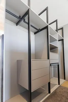 a closet with white and black shelving at HOUSE38 Panoramic View Apartments SELF CHECK-IN in Kaunas