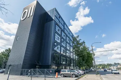a black building with cars parked in front of it at HOUSE38 Panoramic View Apartments SELF CHECK-IN in Kaunas