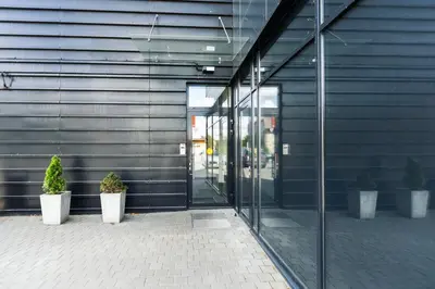 an entrance to an office building with potted plants at HOUSE38 Panoramic View Apartments SELF CHECK-IN in Kaunas