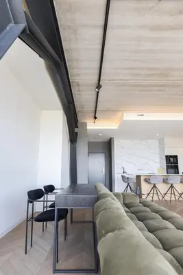 a living room with a couch and a table and chairs at HOUSE38 Panoramic View Apartments SELF CHECK-IN in Kaunas