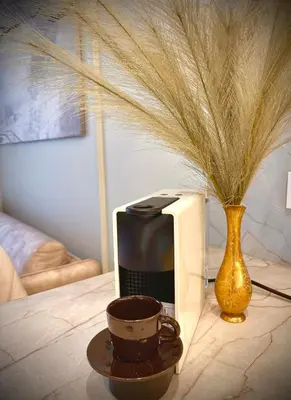 a microwave and a cup of coffee on a table at New luxury apartment & free parking in Vilnius