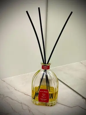 a glass vase with sticks in it on a table at New luxury apartment & free parking in Vilnius