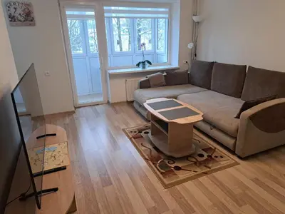 a living room with a couch and a table at Sweet home in Šiauliai