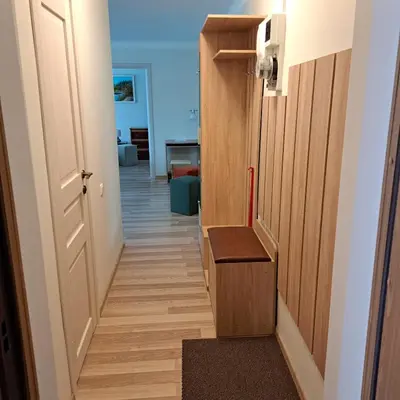 a hallway with a door and a stair case at Sweet home in Šiauliai