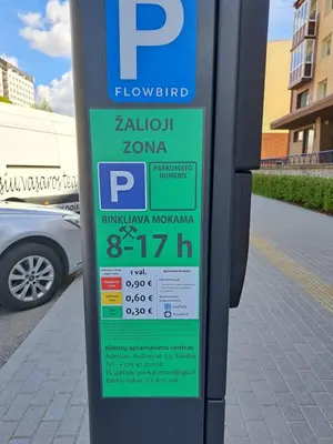 a parking meter sitting on the side of a street at Sweet home in Šiauliai