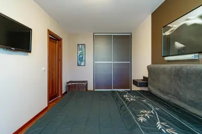 a living room with a couch and a flat screen tv at Panoramic city centre apartment by Polo Apartments in Kaunas