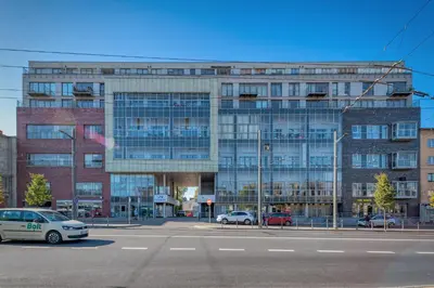 a large building with cars parked in front of it at Panoramic city centre apartment by Polo Apartments in Kaunas