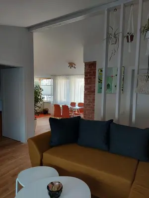 a living room with a couch and a table at Maple Park Apartment in Kaunas