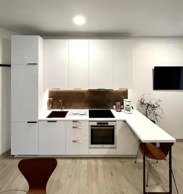 a kitchen with white cabinets and a stove top oven at Kaunas Old Town Apartment in Kaunas