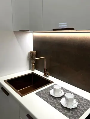 a kitchen with a sink and two cups and saucers at Kaunas Old Town Apartment in Kaunas
