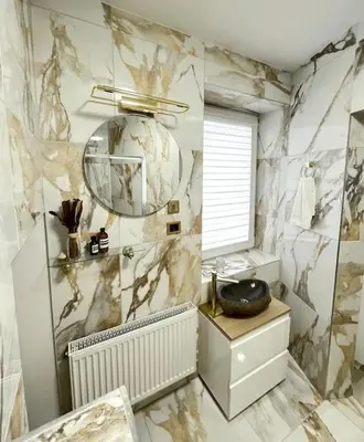 a bathroom with a marble wall with a mirror and a sink at Kaunas Old Town Apartment in Kaunas