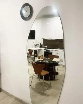a mirror in a kitchen with a table and chairs at Kaunas Old Town Apartment in Kaunas