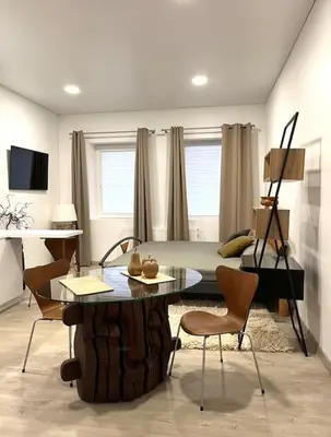 a room with a table and chairs and a bed at Kaunas Old Town Apartment in Kaunas