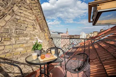 a table with a tray of donuts on a balcony at Luxury apartment in Gediminas avenue with terrace in Vilnius